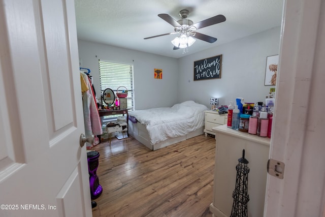 bedroom featuring wood finished floors and ceiling fan