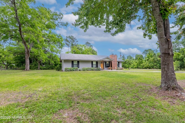 ranch-style house with a front yard and a chimney