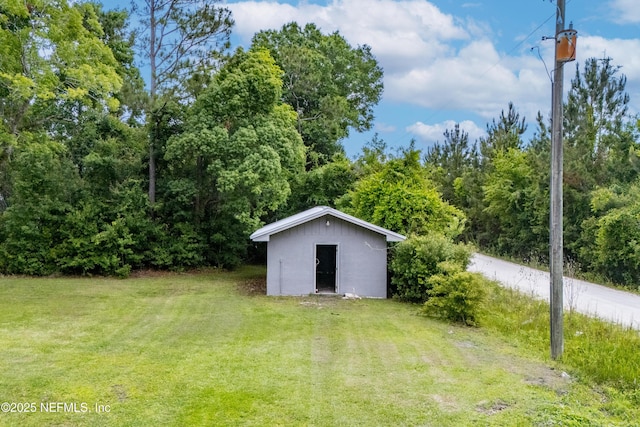 view of grassy yard featuring an outbuilding