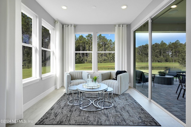 sunroom featuring recessed lighting, outdoor lounge area, baseboards, and tile patterned floors