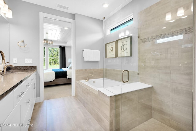 bathroom with ensuite bath, vanity, a shower stall, tile patterned flooring, and a garden tub