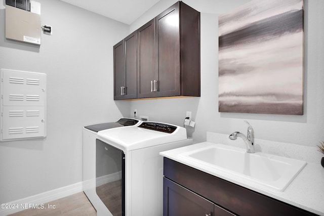 laundry room with washer and clothes dryer, cabinet space, and baseboards