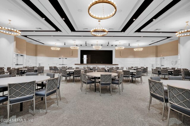 dining room with a chandelier and light carpet
