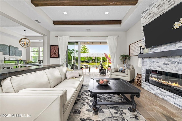 71 Lansing Ct, Saint Augustine, FL 32092 - living area featuring a tray ceiling, wood finished floors, a chandelier, a fireplace, and recessed lighting