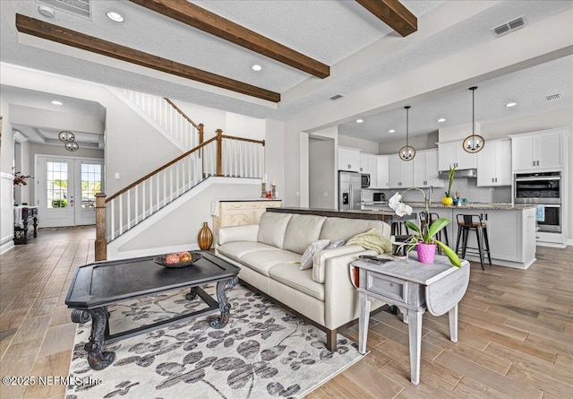 71 Lansing Ct, Saint Augustine, FL 32092 - living room featuring light wood finished floors, beamed ceiling, stairway, french doors, and recessed lighting