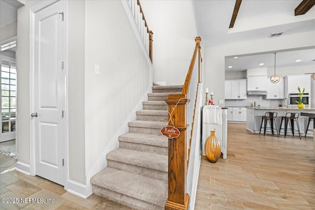 71 Lansing Ct, Saint Augustine, FL 32092 - stairs featuring wood finished floors, baseboards, and recessed lighting