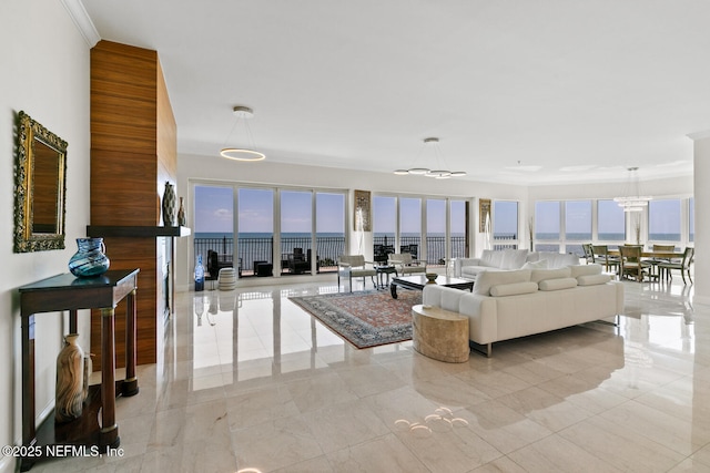 living area with crown molding and a water view