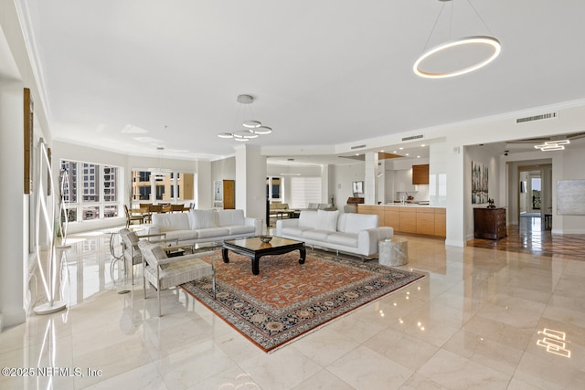 living area with crown molding, healthy amount of natural light, a chandelier, and light marble finish flooring