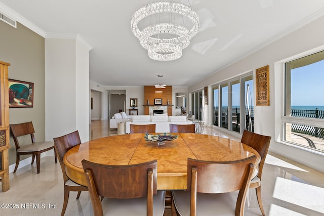 dining room featuring a chandelier and ornamental molding