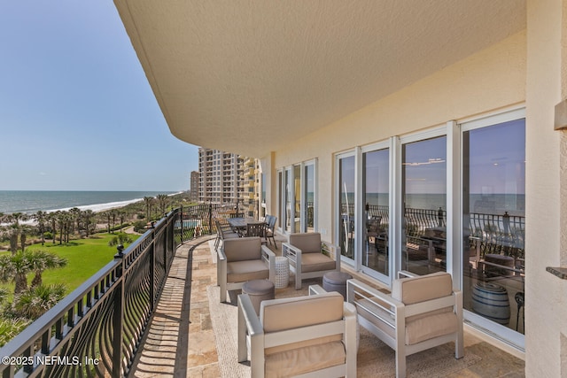 balcony with view of water and beach