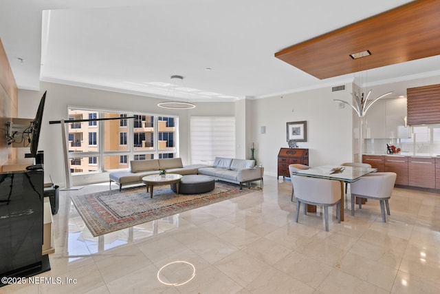 living area with crown molding and light marble finish flooring