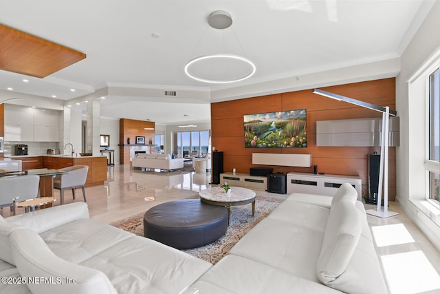 living area with ornamental molding and wooden walls