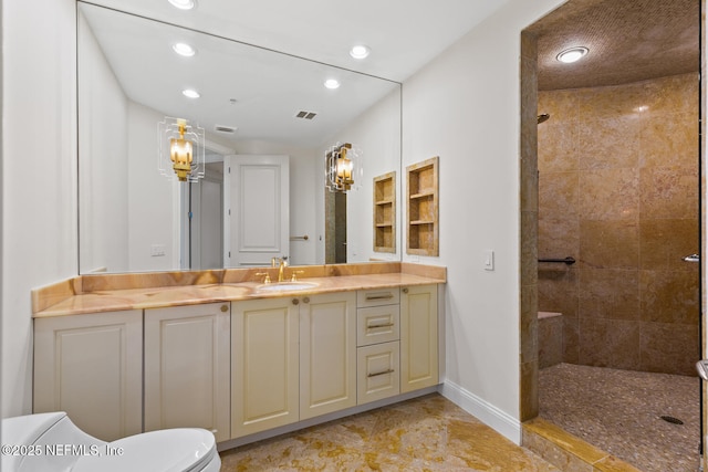 full bathroom featuring a tile shower, recessed lighting, baseboards, vanity, and toilet