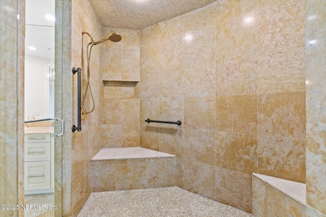 bathroom with tiled shower