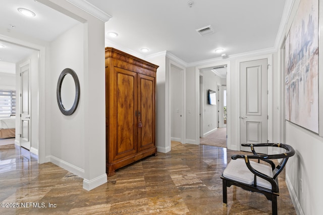 hall with baseboards and crown molding