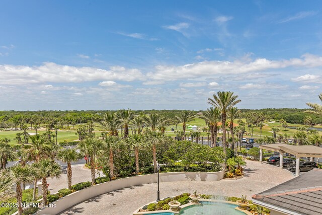 bird's eye view of a golf course and a tree filled landscape