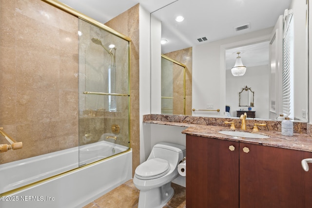 bathroom featuring toilet, enclosed tub / shower combo, and vanity
