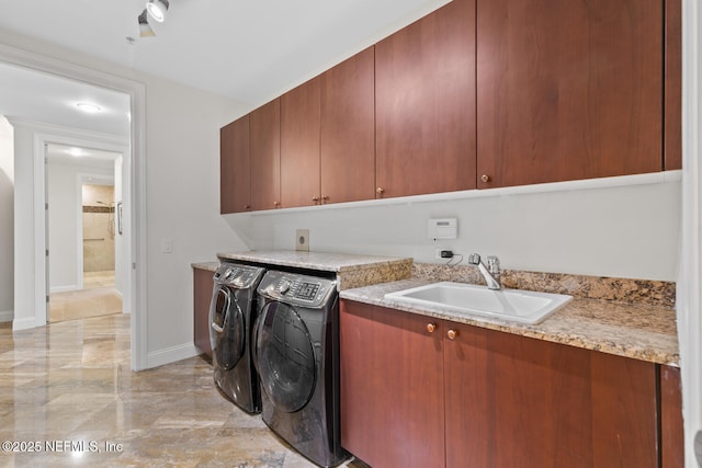 laundry area featuring cabinet space, washer and dryer, light marble finish floors, and baseboards