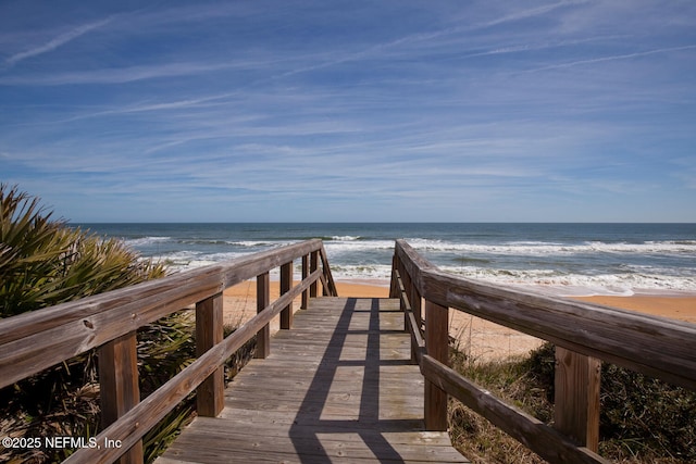 view of community with view of water and beach