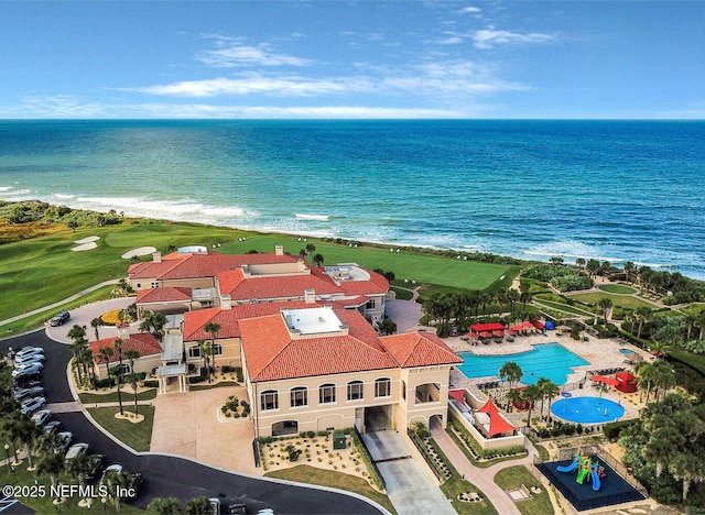 aerial view of a nearby body of water and a pool area