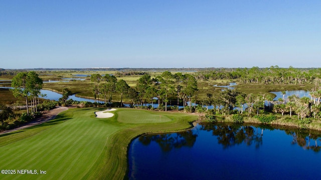 aerial overview of property's location featuring a golf club and a large body of water