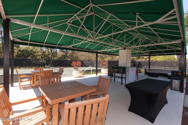 view of patio featuring outdoor dining area, fence, and outdoor lounge area