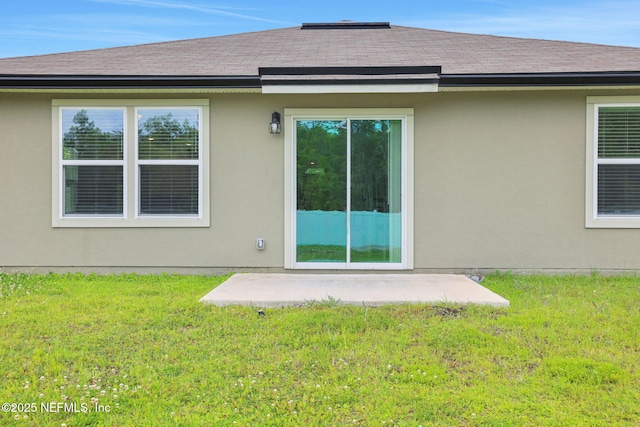 2304 Shady Breeze Ln, Green Cove Springs, FL 32043 - back of property featuring a patio area, a lawn, and stucco siding