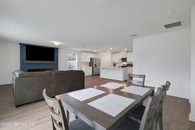 2304 Shady Breeze Ln, Green Cove Springs, FL 32043 - dining area with light wood-style floors and baseboards
