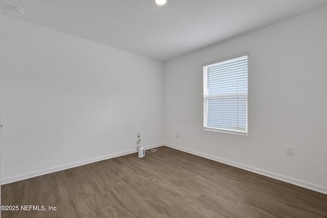 2304 Shady Breeze Ln, Green Cove Springs, FL 32043 - empty room featuring dark wood-type flooring and baseboards