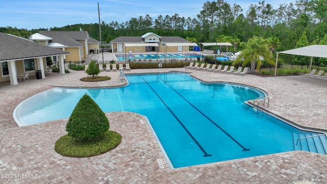 2304 Shady Breeze Ln, Green Cove Springs, FL 32043 - community pool featuring fence, a patio area, and view of wooded area