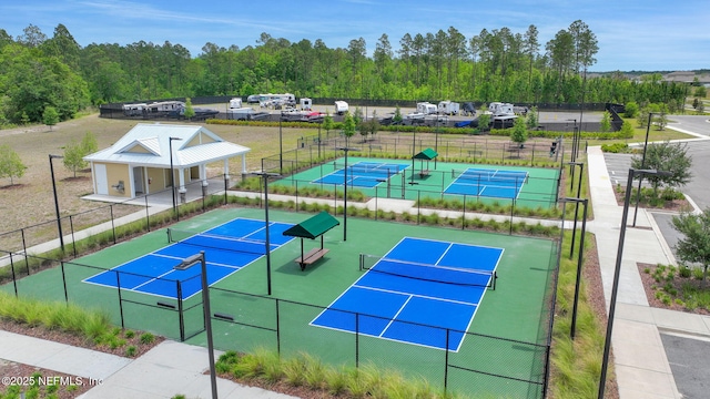 2304 Shady Breeze Ln, Green Cove Springs, FL 32043 - view of tennis court featuring fence and a forest view