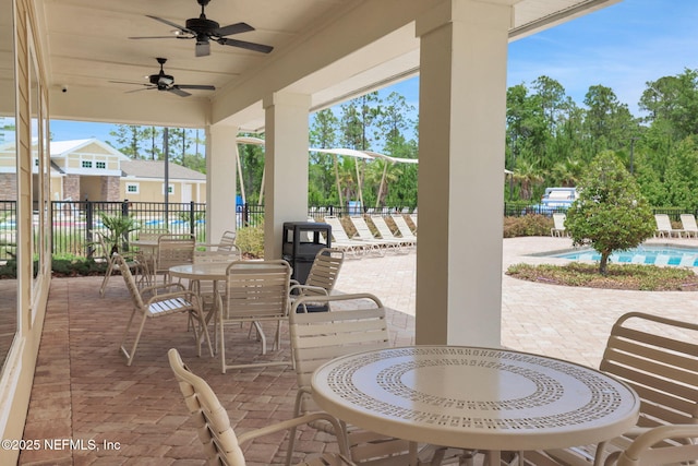 2304 Shady Breeze Ln, Green Cove Springs, FL 32043 - view of patio / terrace featuring fence, a community pool, a ceiling fan, and outdoor dining space
