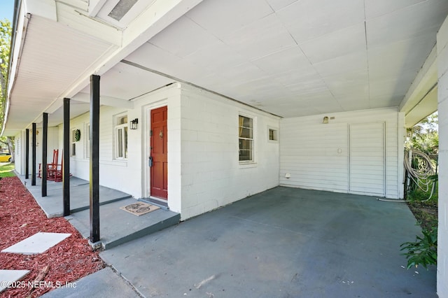 5388 Woodcrest Rd, Jacksonville, FL 32205 - property entrance featuring a carport, a porch, and concrete block siding