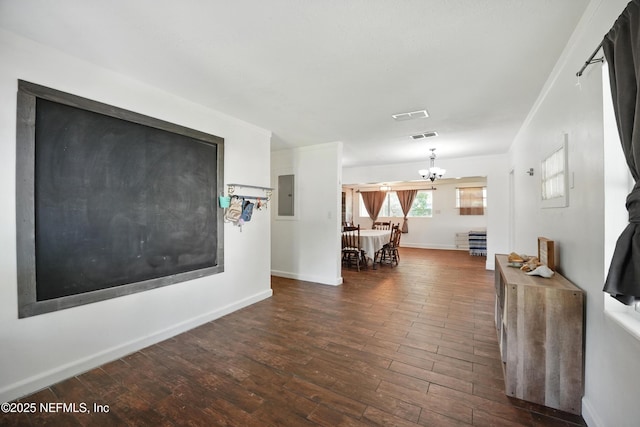 5388 Woodcrest Rd, Jacksonville, FL 32205 - living room featuring wood finished floors, a chandelier, baseboards, and electric panel