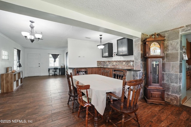 5388 Woodcrest Rd, Jacksonville, FL 32205 - dining area with dark wood-type flooring, a chandelier, and a textured ceiling