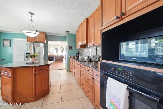 5388 Woodcrest Rd, Jacksonville, FL 32205 - kitchen featuring black appliances, light tile patterned flooring, tasteful backsplash, dark stone counters, and a textured ceiling