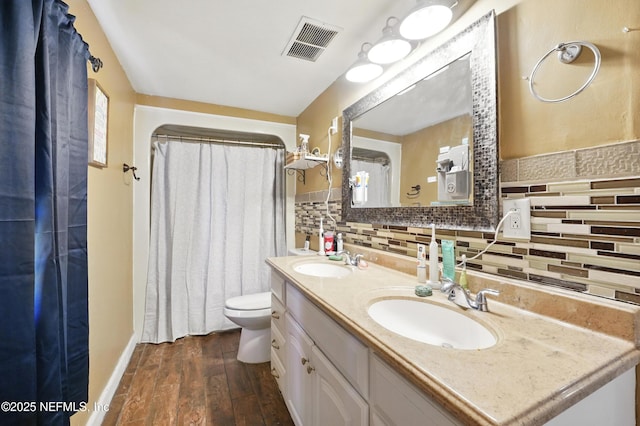 5388 Woodcrest Rd, Jacksonville, FL 32205 - bathroom featuring hardwood / wood-style floors, backsplash, toilet, double vanity, and baseboards