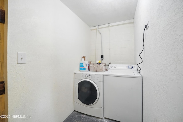 5388 Woodcrest Rd, Jacksonville, FL 32205 - clothes washing area featuring washer and dryer and a textured wall