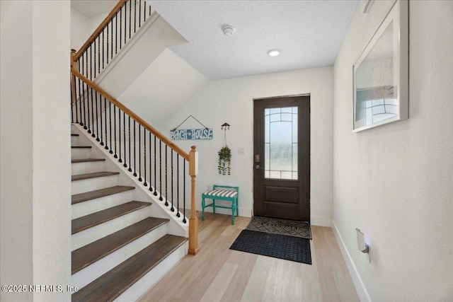 2777 S Ponte Vedra Blvd, Ponte Vedra Beach, FL 32082 - entrance foyer featuring wood finished floors, stairs, baseboards, and a textured ceiling