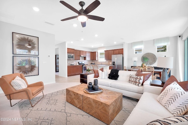 living room with ceiling fan, recessed lighting, and baseboards