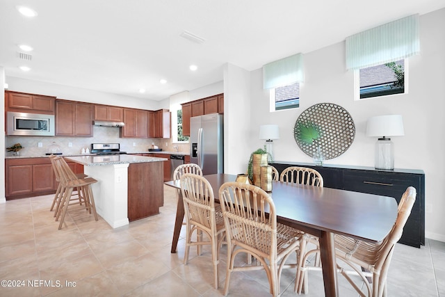 dining area featuring recessed lighting, light tile patterned floors, and baseboards