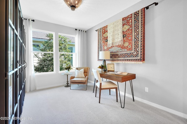 sitting room featuring carpet flooring, baseboards, and a desk