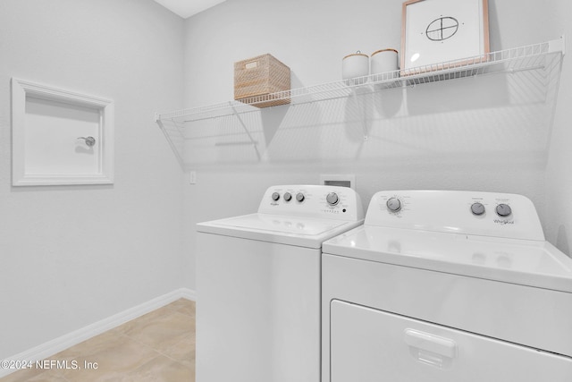 washroom featuring separate washer and dryer and baseboards