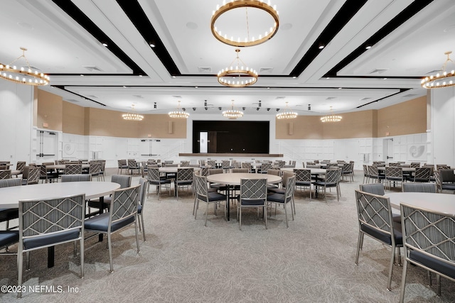dining room featuring a chandelier and light colored carpet