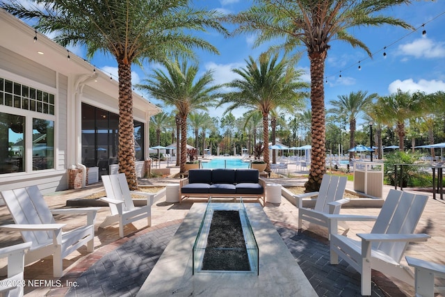 view of patio featuring a community pool and an outdoor living space