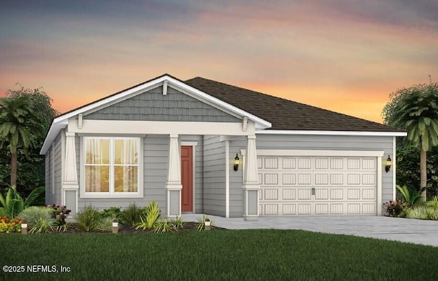 view of front of house featuring an attached garage, concrete driveway, and a lawn