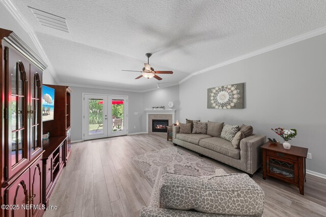 116 Greenfield Dr, Saint Johns, FL 32259 - living area featuring ceiling fan, a textured ceiling, vaulted ceiling, light wood-style floors, and ornamental molding