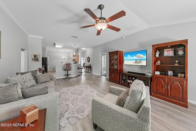 116 Greenfield Dr, Saint Johns, FL 32259 - living room featuring ornamental molding, a ceiling fan, light wood finished floors, a textured ceiling, and baseboards