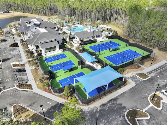 bird's eye view of a heavily wooded area and a pool area