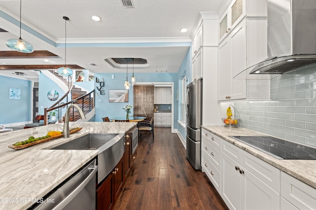 182 N Ridge Dr, Fleming Island, FL 32003 - kitchen featuring wall chimney exhaust hood, stainless steel appliances, light stone countertops, a sink, and glass insert cabinets